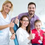 happy family with dentist after a successful dental checkup and treatment